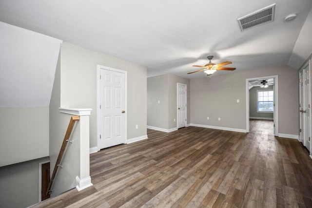 unfurnished living room with baseboards, visible vents, and wood finished floors