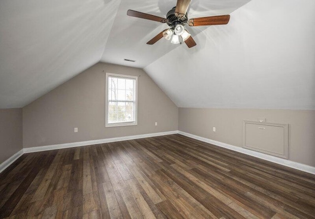 additional living space featuring vaulted ceiling, visible vents, dark wood finished floors, and baseboards