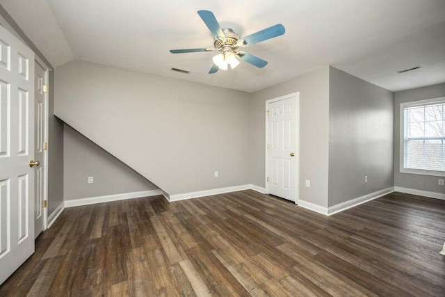 unfurnished bedroom featuring ceiling fan, wood finished floors, visible vents, and baseboards