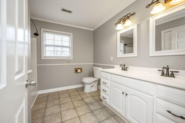 bathroom with toilet, ornamental molding, a sink, and visible vents