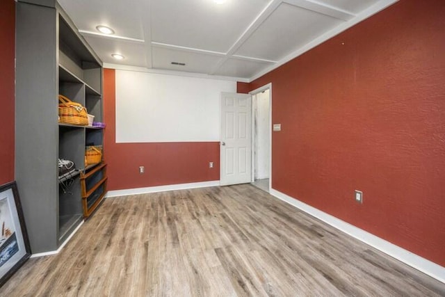 unfurnished room featuring built in features, baseboards, and wood finished floors