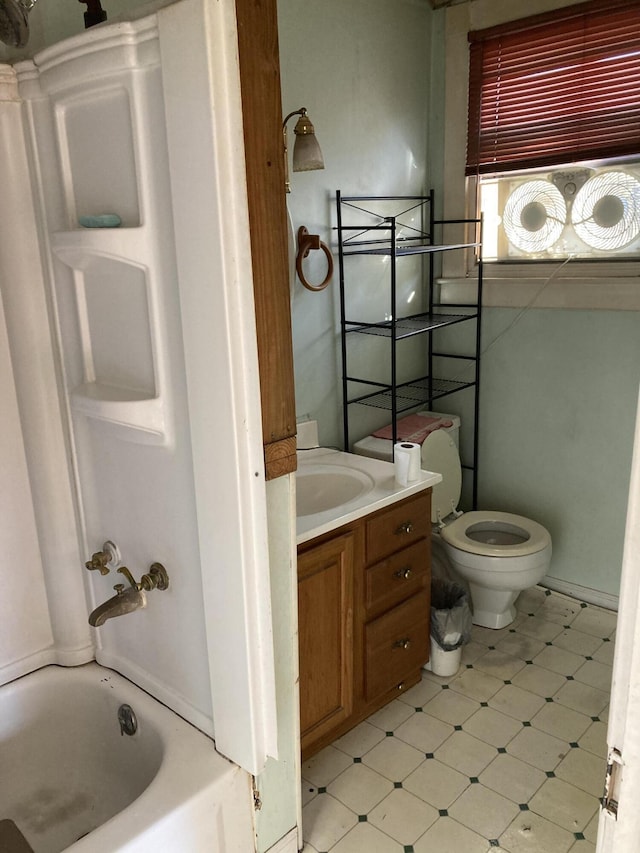 full bath with vanity, toilet, and tile patterned floors