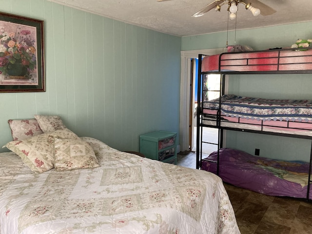 bedroom featuring a textured ceiling and a ceiling fan