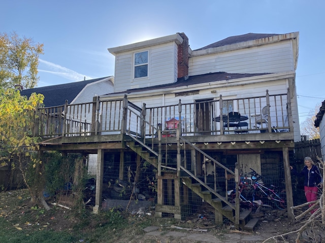 rear view of house with stairway and a wooden deck