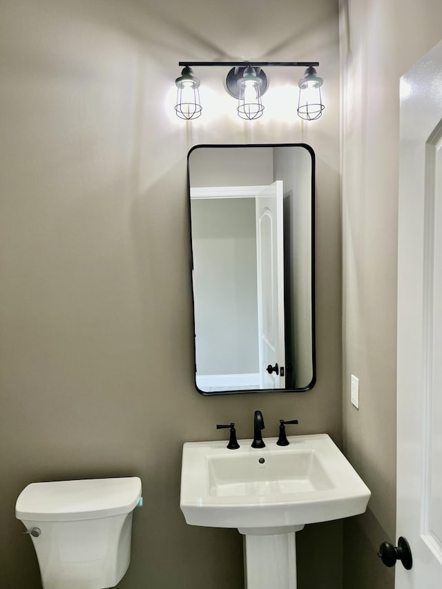 bathroom featuring toilet and a sink