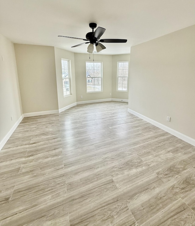 unfurnished room with light wood-type flooring, baseboards, and ceiling fan