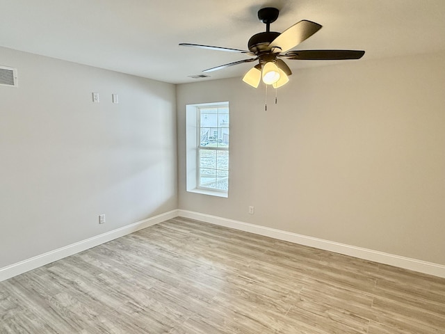 unfurnished room with visible vents, baseboards, and light wood-style floors