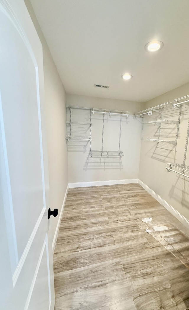 walk in closet featuring light wood finished floors and visible vents