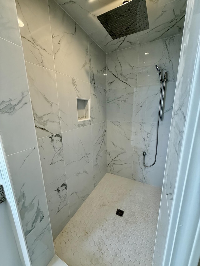 full bathroom featuring a marble finish shower