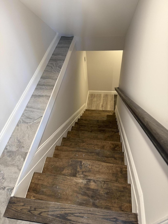 stairs with baseboards and wood finished floors