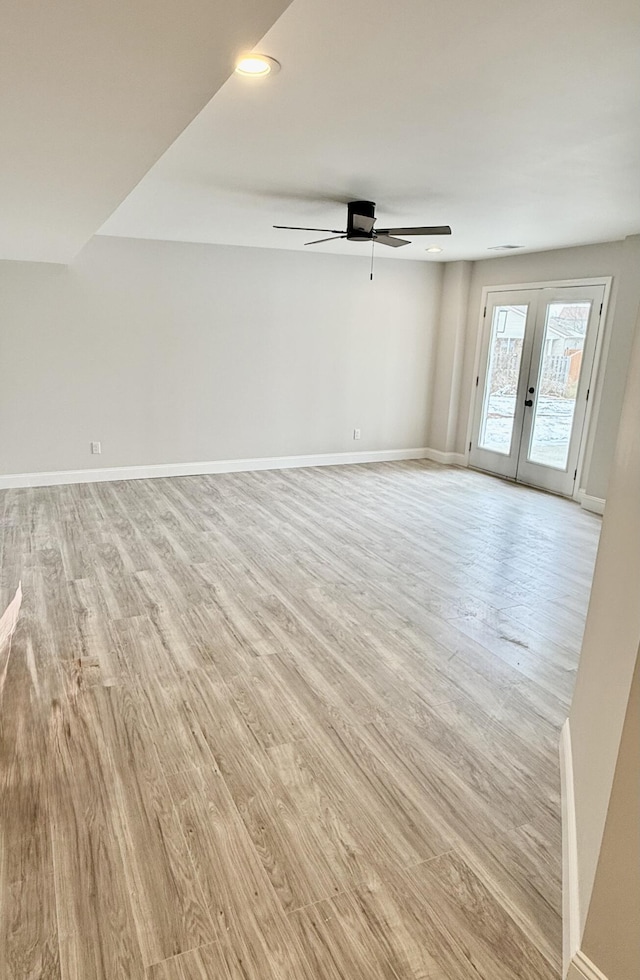 unfurnished living room with baseboards, recessed lighting, ceiling fan, french doors, and light wood-type flooring