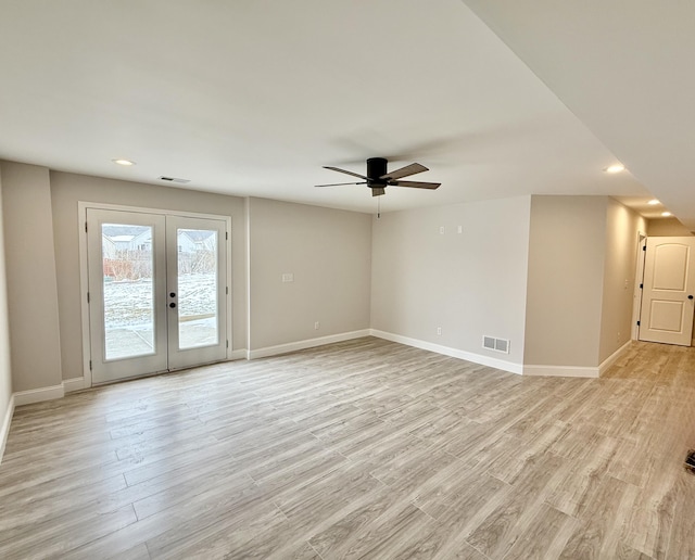 unfurnished room with light wood finished floors, visible vents, french doors, and baseboards