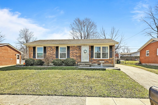 ranch-style house featuring driveway, brick siding, a front lawn, and fence