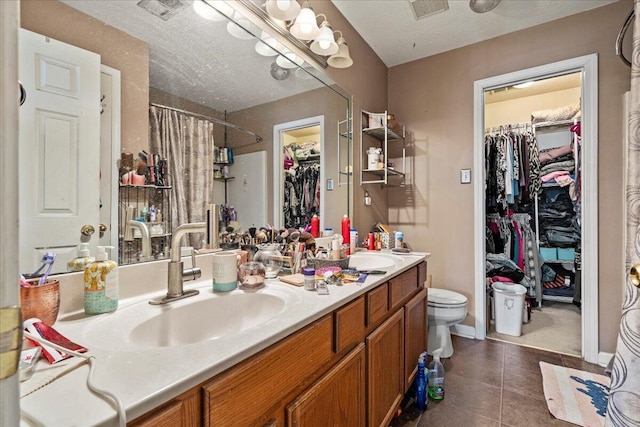 full bath featuring a shower with shower curtain, visible vents, double vanity, a sink, and tile patterned flooring