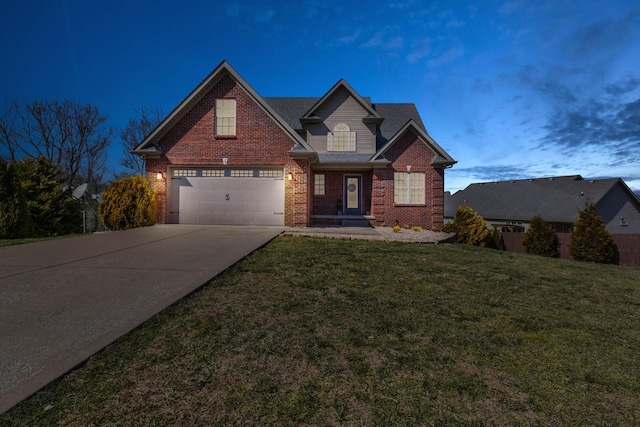 traditional-style home with a garage, a front yard, brick siding, and driveway