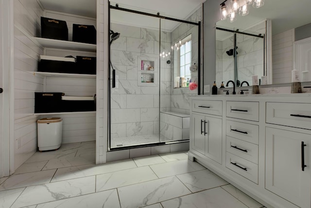 bathroom with marble finish floor, a stall shower, and vanity