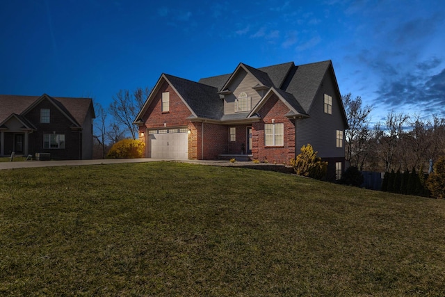 view of front of house featuring a front yard, a garage, brick siding, and driveway