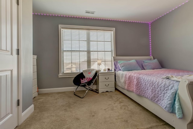 bedroom featuring visible vents, light carpet, and baseboards