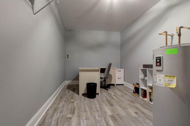 office space with electric water heater, baseboards, and wood finished floors