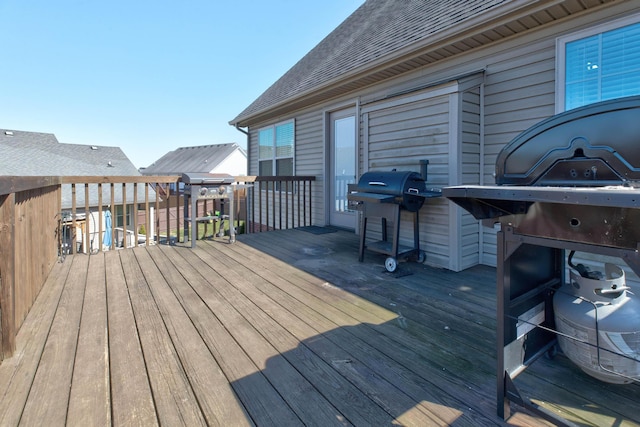 wooden terrace with a grill