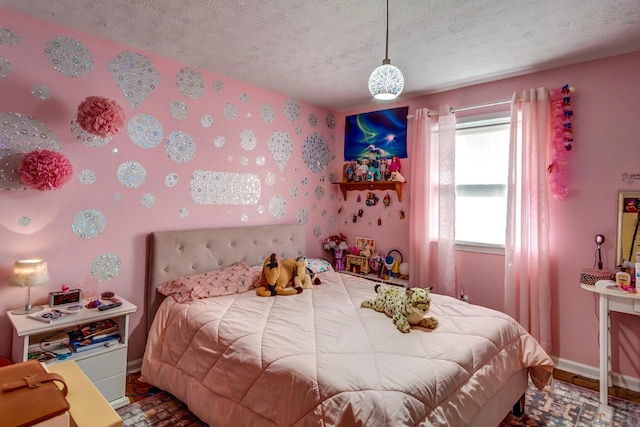 bedroom featuring baseboards and a textured ceiling