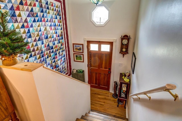 entrance foyer featuring wood finished floors and stairs