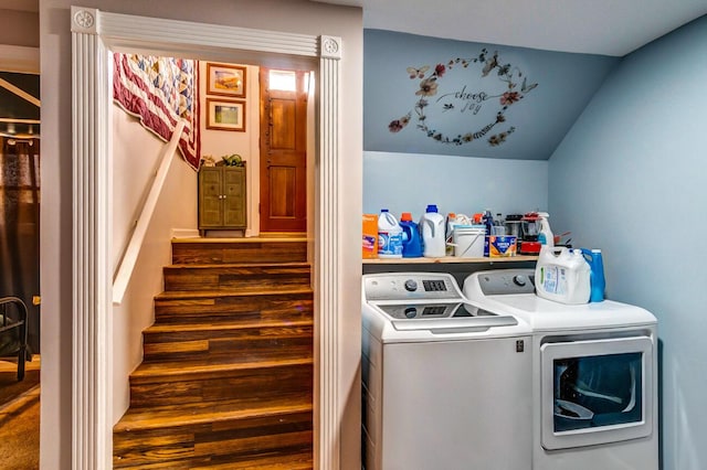 laundry room with laundry area, wood finished floors, and washing machine and clothes dryer