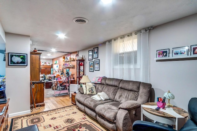 living area featuring visible vents and light wood-style floors