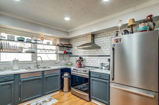 kitchen featuring open shelves, light wood-style flooring, appliances with stainless steel finishes, a sink, and wall chimney range hood