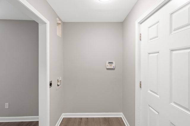 washroom featuring laundry area, hookup for a washing machine, dark wood-type flooring, and baseboards