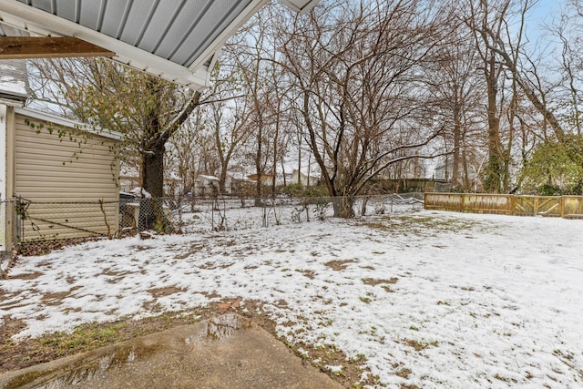 yard covered in snow featuring fence