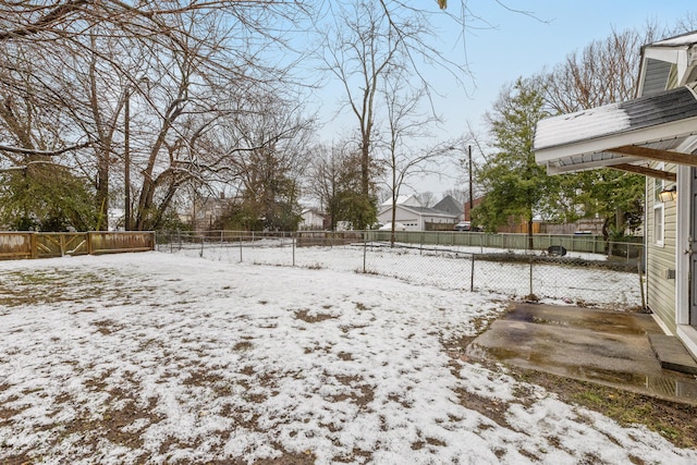 snowy yard with fence