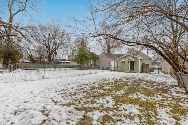 yard layered in snow featuring a fenced backyard