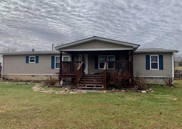 view of front of house featuring a porch, a front yard, crawl space, and metal roof