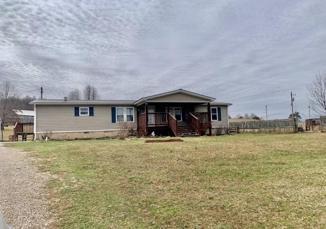 manufactured / mobile home featuring covered porch, a front lawn, crawl space, and fence