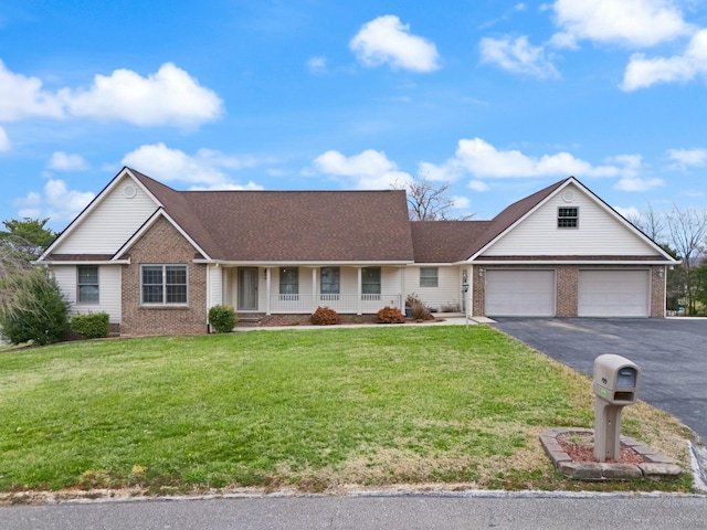 ranch-style house featuring aphalt driveway, covered porch, brick siding, and a front yard