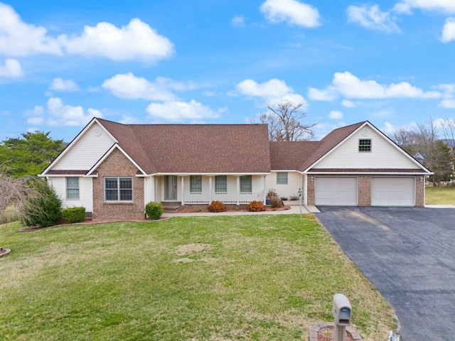 ranch-style house with aphalt driveway, brick siding, and a front yard