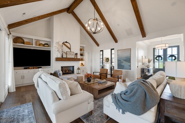 living room with beam ceiling, an inviting chandelier, dark wood-type flooring, a large fireplace, and high vaulted ceiling