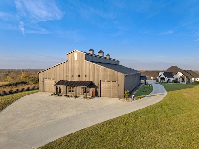 view of outbuilding with concrete driveway and fence