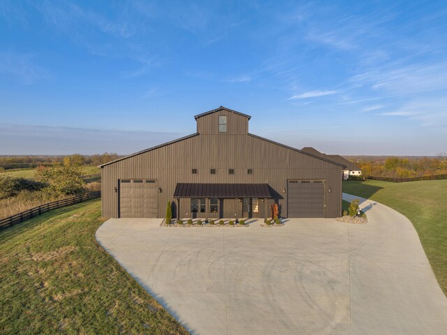 exterior space featuring driveway, fence, and a front lawn