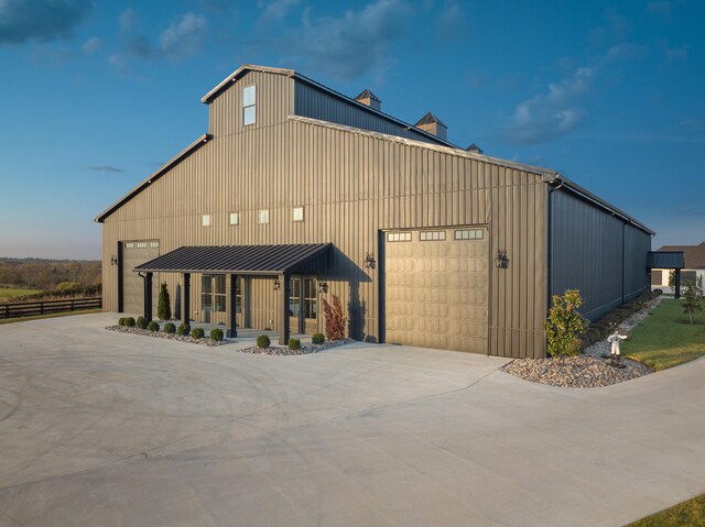 view of building exterior featuring concrete driveway and an attached garage