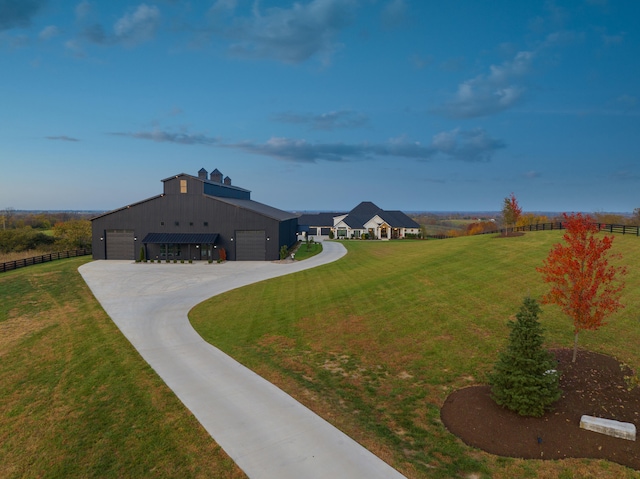 view of front of house featuring driveway, a front lawn, and fence