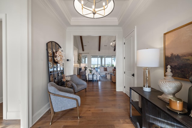 entrance foyer with vaulted ceiling with beams, an inviting chandelier, ornamental molding, wood finished floors, and baseboards