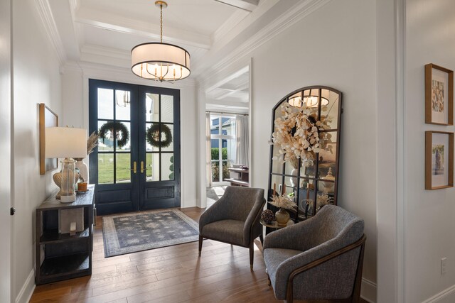 foyer with baseboards, ornamental molding, hardwood / wood-style floors, and french doors