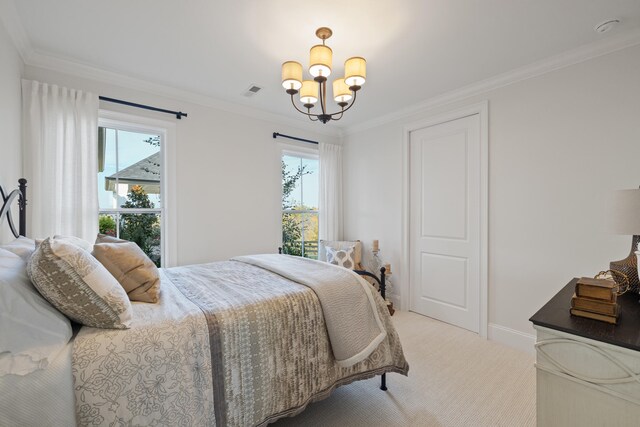 carpeted bedroom featuring multiple windows, ornamental molding, and a chandelier