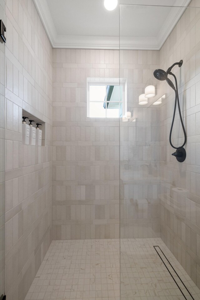 full bath with ornamental molding and a tile shower