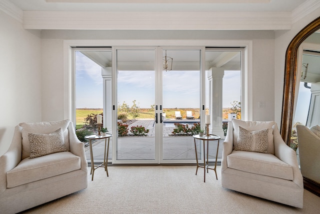 sitting room with carpet, ornamental molding, and a wealth of natural light