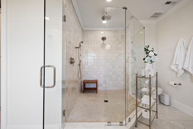 bathroom featuring visible vents, toilet, marble finish floor, crown molding, and a shower stall