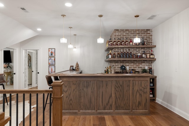 bar featuring indoor wet bar, recessed lighting, visible vents, wood finished floors, and baseboards