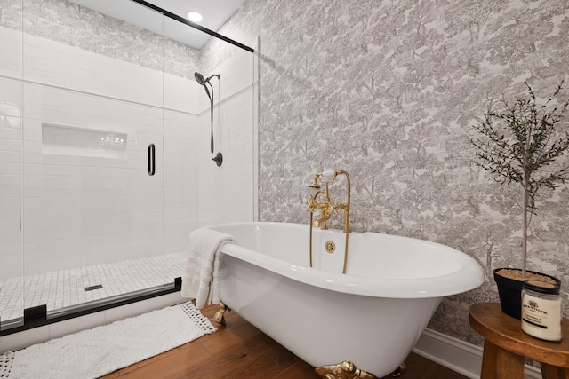 full bath with a freestanding tub, a stall shower, and wood finished floors